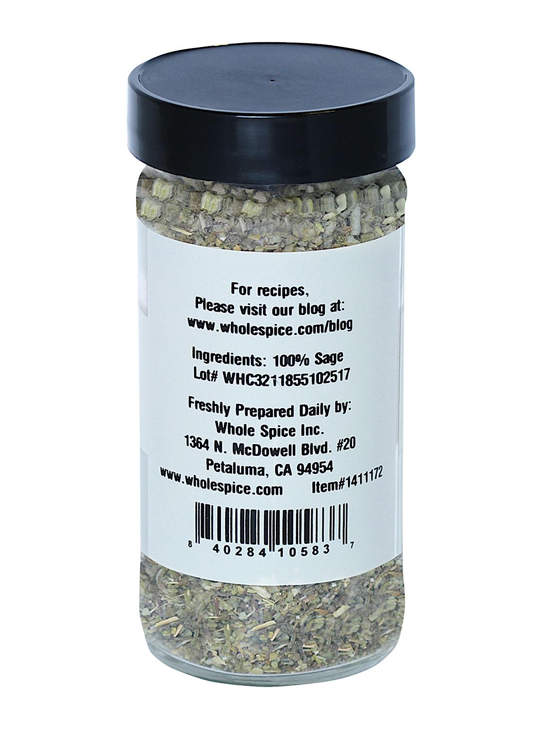 A clear spice jar labeled "Sage Crushed" from Whole Spice Inc. features a black lid and is filled with dried sage leaves (ingredients: 100% sage); the label includes company contact details and a barcode.