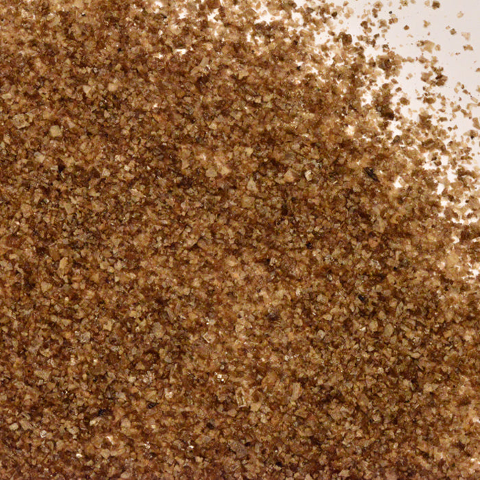 A pile of brown crystals of Whole Spice Inc. Applewood Smoked Sea Salt.