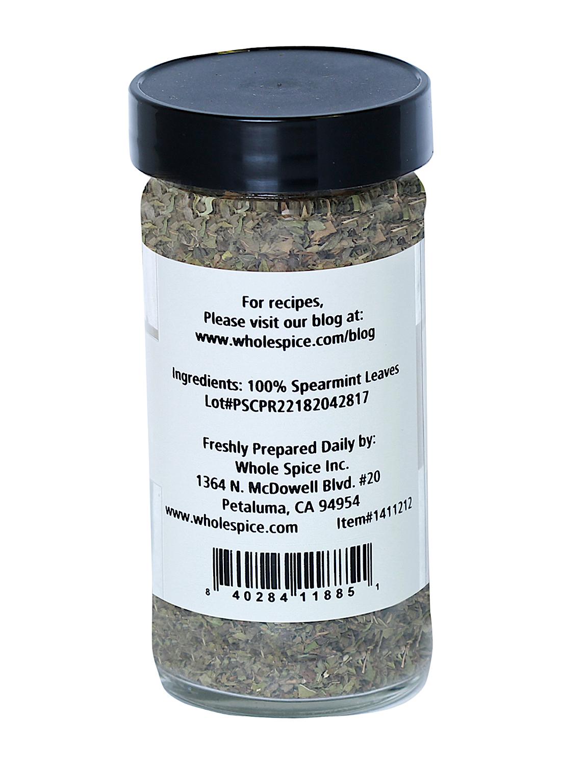 Spearmint Leaves by Whole Spice Inc. come in a clear glass jar with a black lid, containing only 100% spearmint leaves—ideal for adding fresh mint flavor to your dishes. Label includes company and location details.