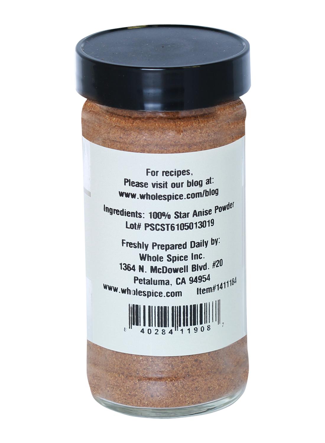 A glass spice jar with a black lid contains Whole Spice Inc. Star Anise Powder, labeled as 100% star anise—a key ingredient in five-spice powder—with company and contact details provided.
