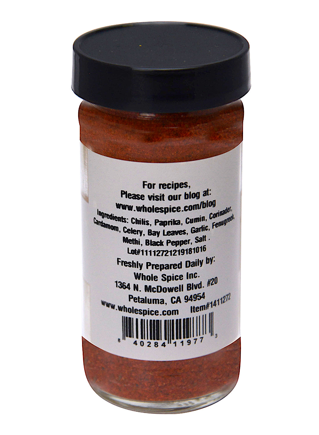 A clear spice jar with a black lid reveals Whole Spice Inc.'s vibrant red-orange Tandoori Spice Rub, featuring chili, paprika, and cumin—ideal for tandoori dishes or classic Indian seasoning. Label includes company info and recipe website.
