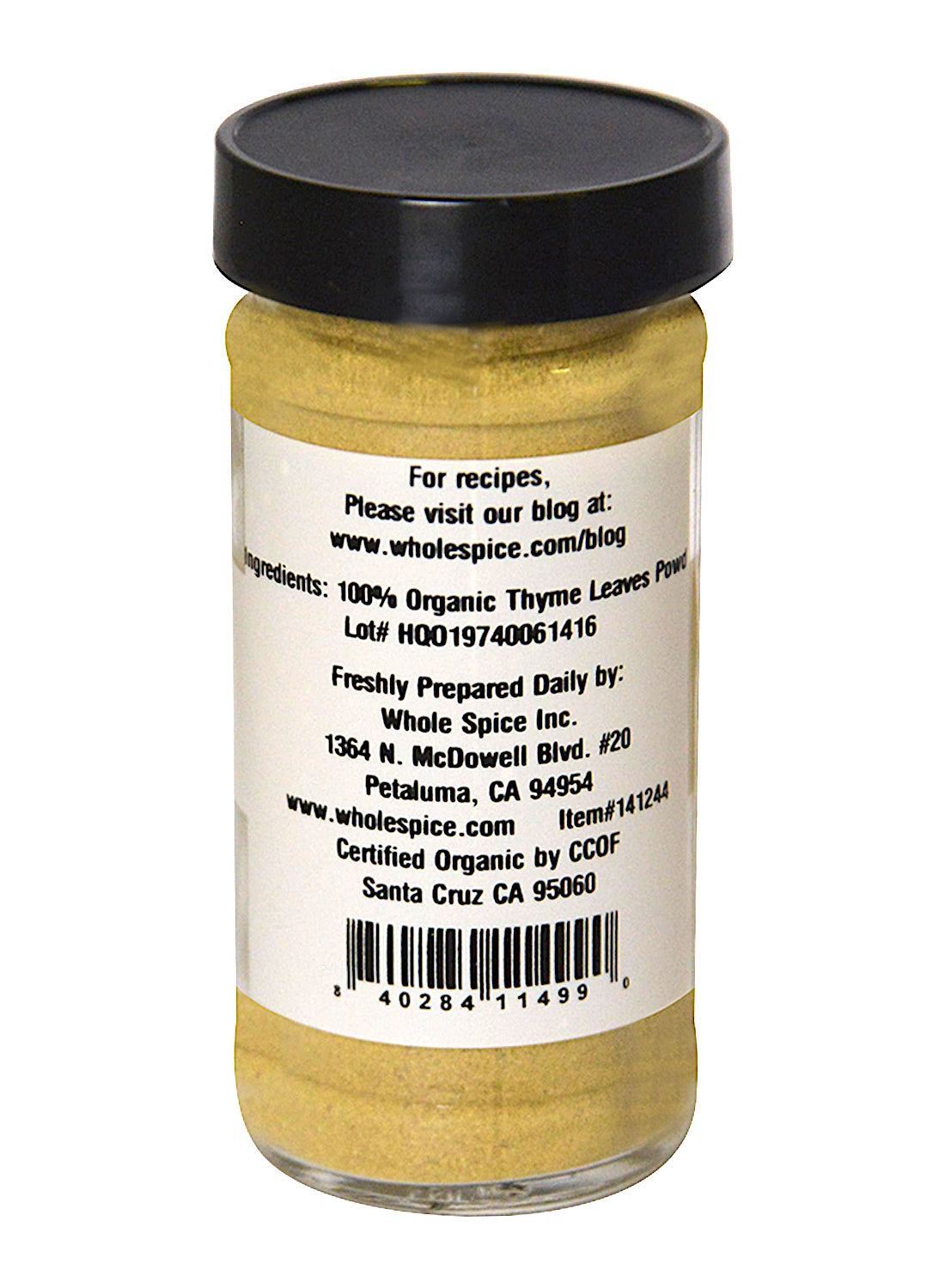 A glass jar with a black lid holds Whole Spice Inc. Thyme Powder Organic, a versatile herb. The label displays ingredients, manufacturer info, certification, website link, and a barcode at the bottom.