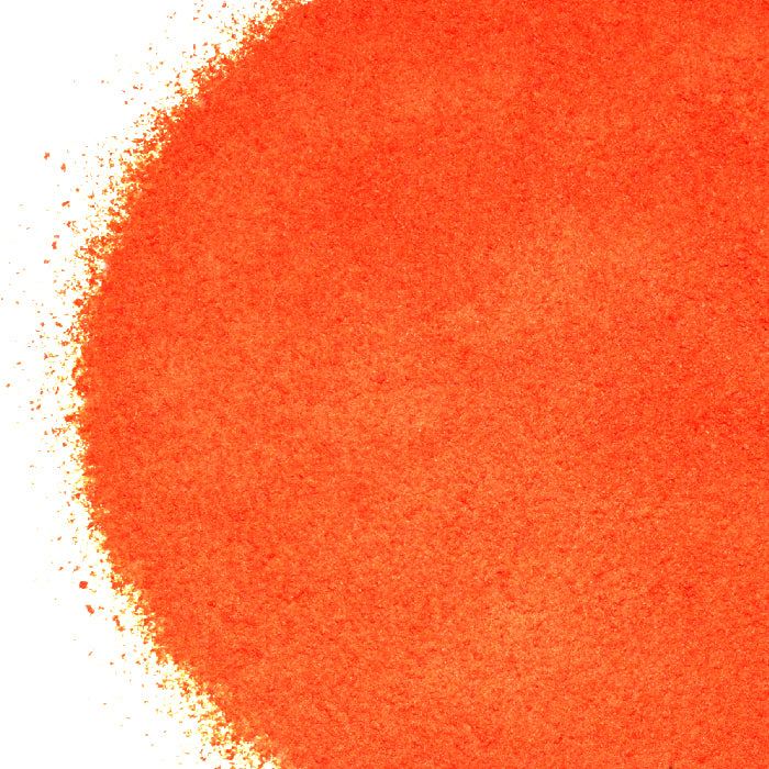 A close-up of Whole Spice Inc. Tomato Powder shows its vibrant color and fine texture, spread in a circle with uneven edges on a white background.