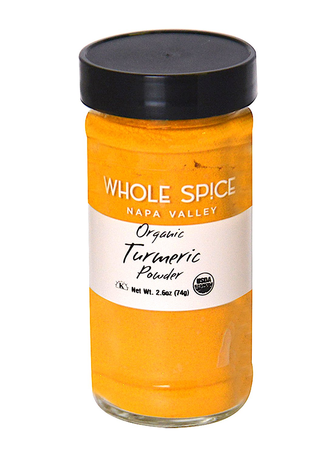 A glass jar of Whole Spice Inc. Turmeric Powder Organic with a black lid and white label displaying branding, 2.6oz/74g weight, and certification logos. This bright yellow-orange spice is ideal for curry blends or flavorful Indian dishes.