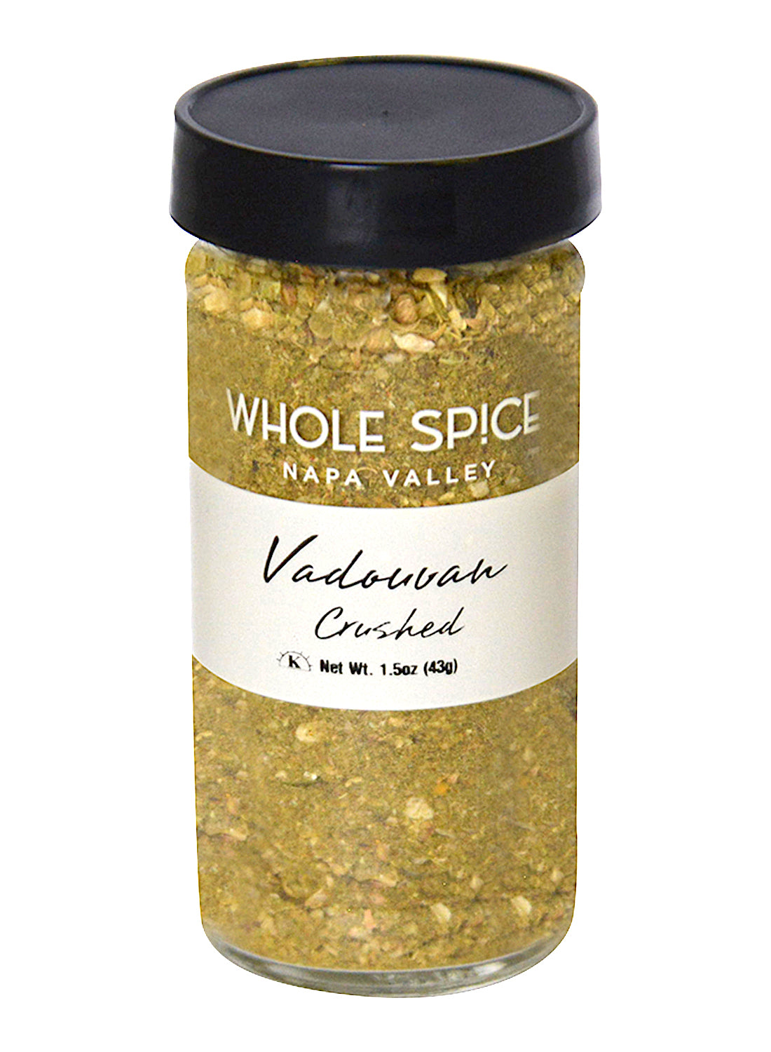 A glass jar with a black lid holds Whole Spice Inc. Vadouvan Crushed, a flavorful curry powder blend. The white label displays the product name in black text and net weight: 1.5 oz (43g).