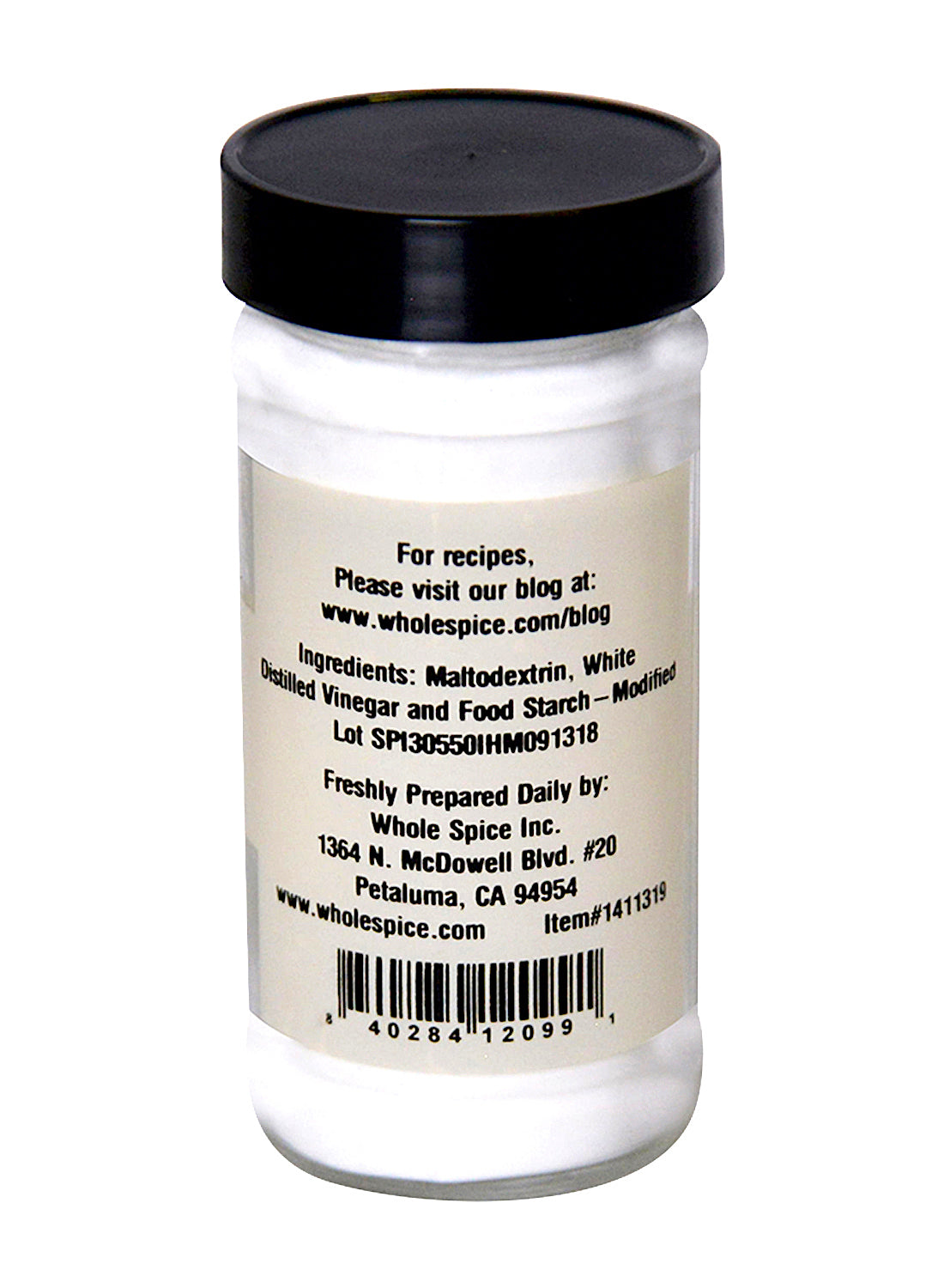 A clear spice jar with a black lid, labeled with ingredients, contact info, and barcode on the back, holds Whole Spice Inc. Vinegar Powder, a popular seasoning ingredient.