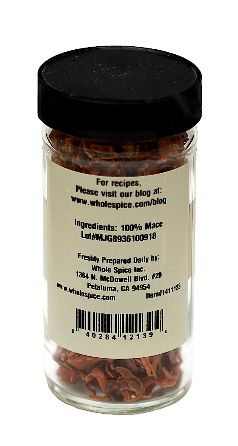 A clear glass jar with a black lid contains Whole Spice Inc.'s Mace Whole. The white label lists ingredients, company details, and website—ideal for adding depth to French cuisine. Made in Petaluma, California.